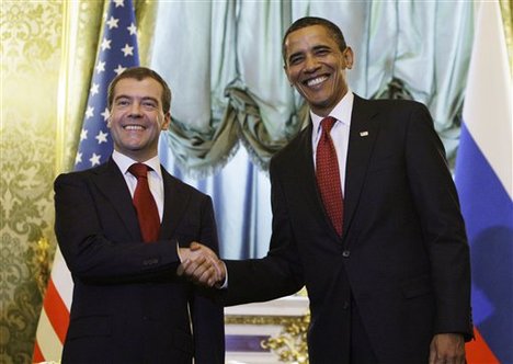 U.S. President Barack Obama, left, and Russian President Dmitry Medvedev sign a new nuclear arms control agreement today in Prague 